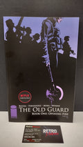 (MATURE) The Old Guard Book One: Opening Fire by Greg Rucka – New Paperback (Minor Wear)