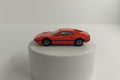 A red Matchbox Ferrari 308 GTB toy car on a plain background