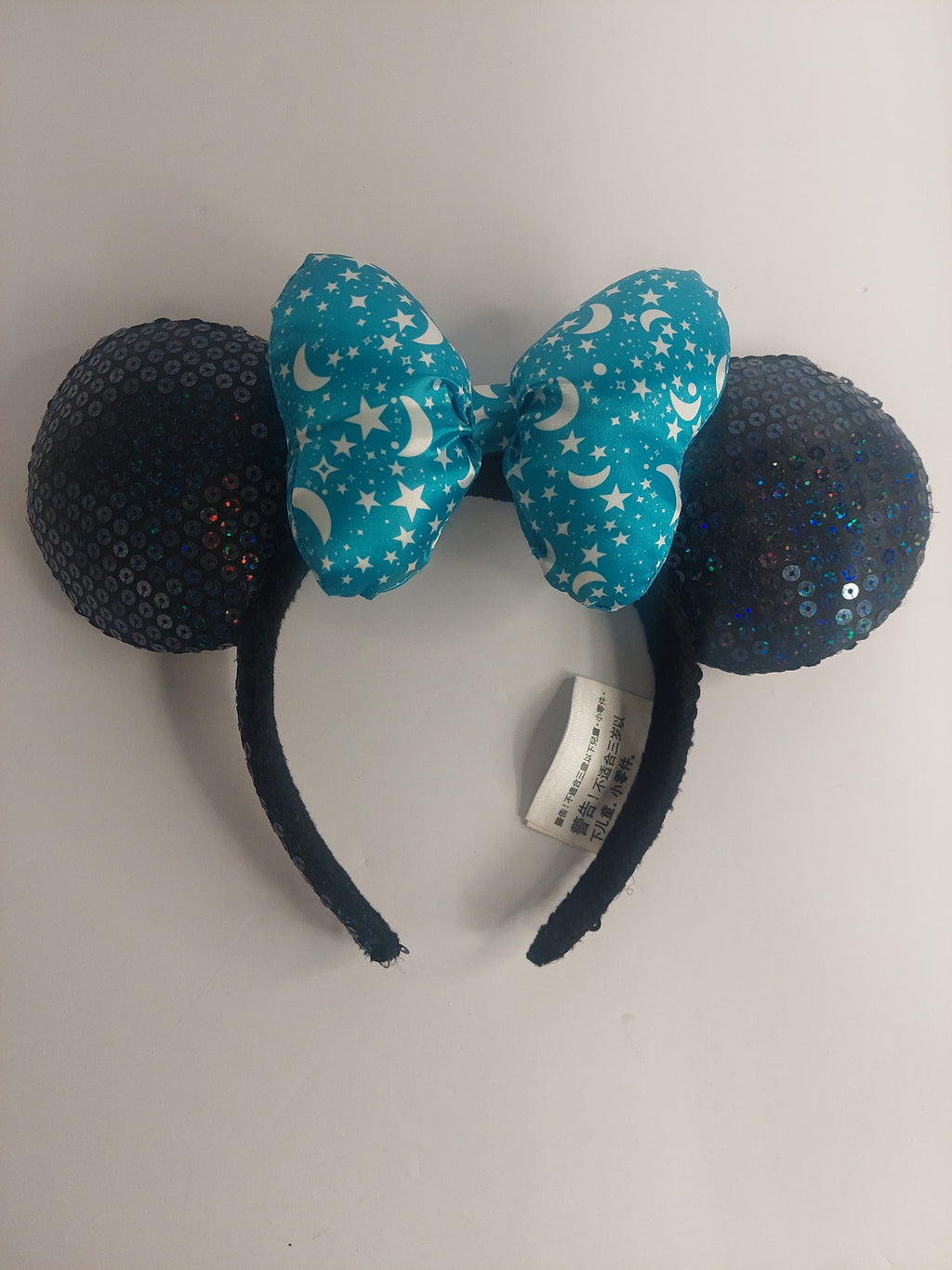 Blue and black decorative headband with sequins on a white background