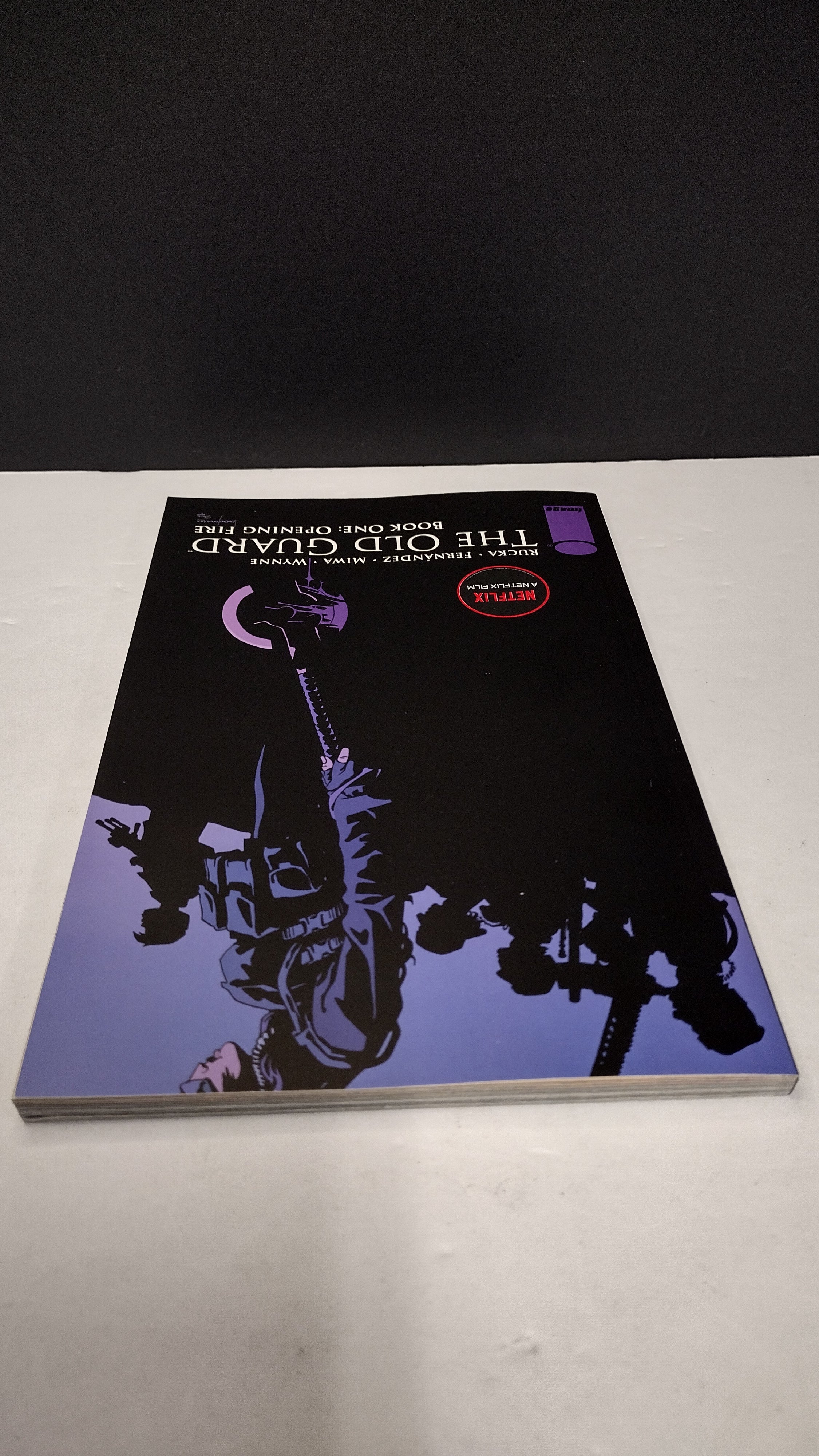 (MATURE) The Old Guard Book One: Opening Fire by Greg Rucka – New Paperback (Minor Wear)