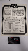 An open vintage Star Wars retro instruction booklet showing black-and-white assembly/playset drawings, placed next to a black 'Retro Blast!' box on a white surface.
